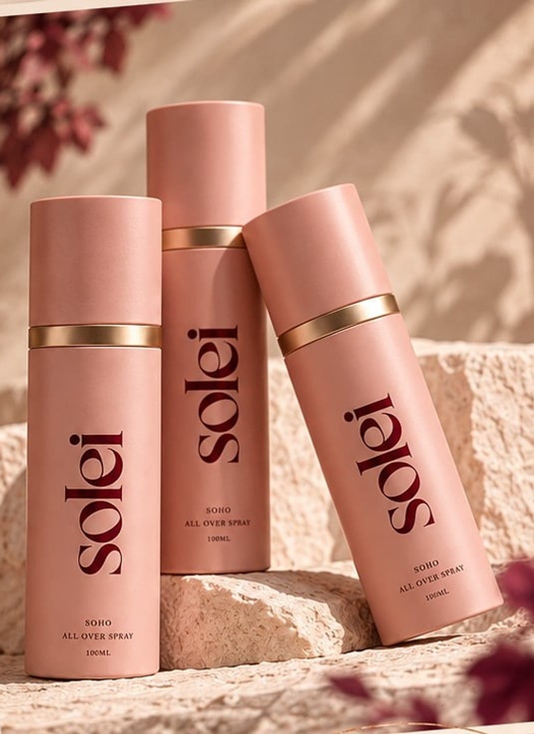 Three Solei all-over sprays resting on warm stone